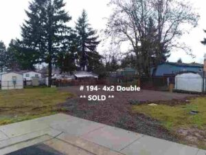 A house for sale with a sign that says sold, now ready for 17 new beautiful manufactured homes.