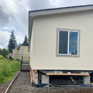 A mobile home is being built on a lot where All 17 Homes Have Arrived at Clairmont.