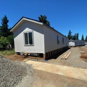 A mobile home is being built on a dirt lot where all 17 homes have arrived at Clairmont.