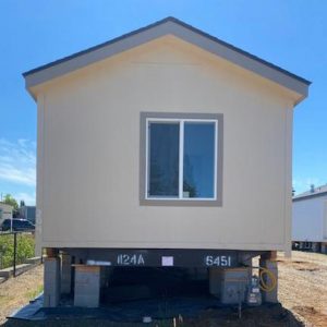 Keywords: mobile home, built. 

Description: A mobile home is being built in a lot where all 17 homes have arrived at Clairmont.