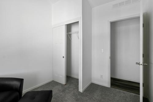 An empty room with a chair and a closet.
