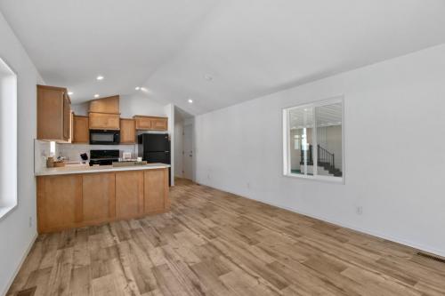 An empty kitchen with wood floors and hardwood floors.