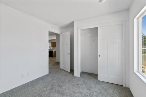 An empty room with white walls and a door.