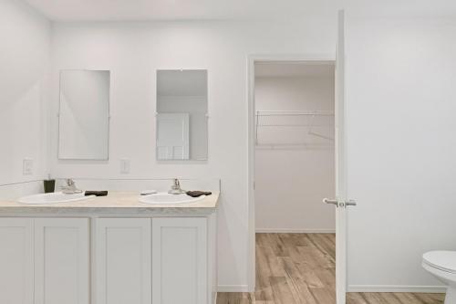 A white bathroom with a toilet and sink.