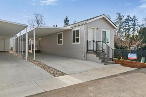 A mobile home with a garage and driveway.