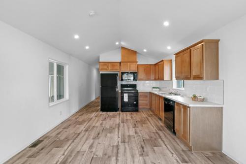 A kitchen with hardwood floors and wood cabinets.